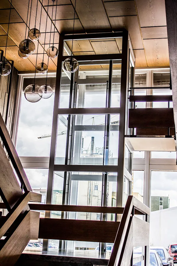 Moderne Rollstuhl-Hebebühne in lichtdurchfluteter Galerie eines Gebäudes